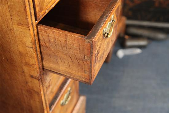 A George II featherbanded walnut kneehole desk, W.3ft 2.5in. D.1ft 10.5in. H.2ft 9in.